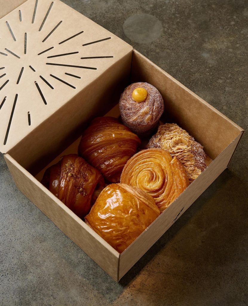 a box of croissants and other desserts by lune