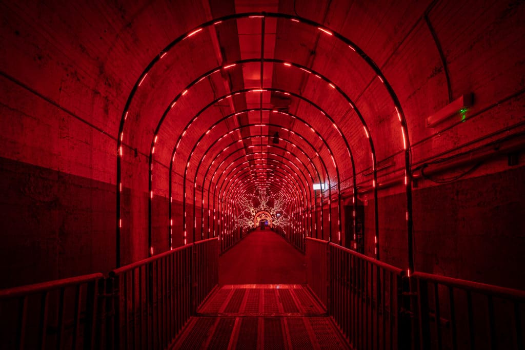 an empty tunnel lit up with red lights