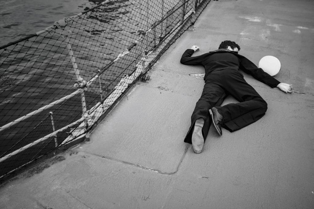 black and white photo of immersive experience where a sailor is dead, lying face down on the deck of a ship