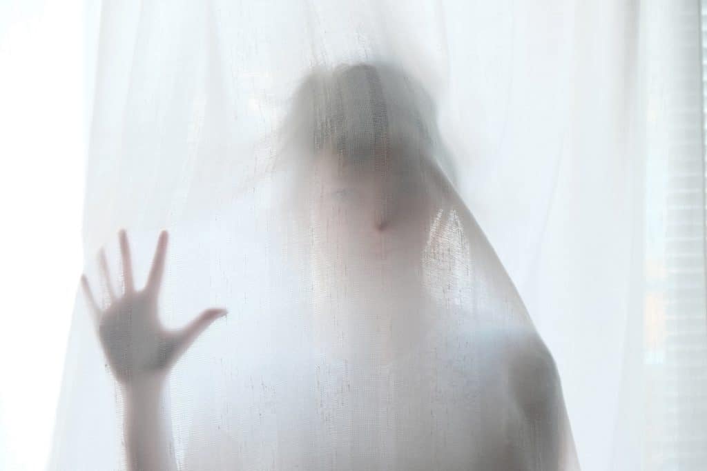person behind see-through white curtain, ghostly appearance