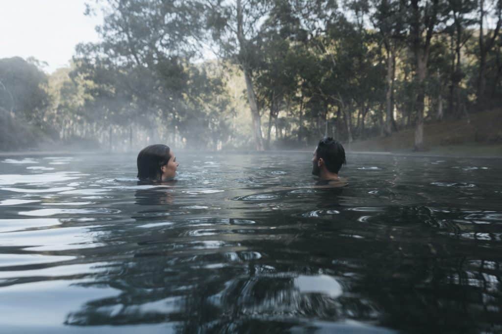 Couple enjoying a dip in the natural thermal springs in the Yarrongobilly area, Kosciuszko National Park.