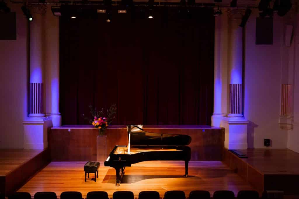 a black steinway grand piano on stage at the independent theatre in Sydney for concert and cake sundays