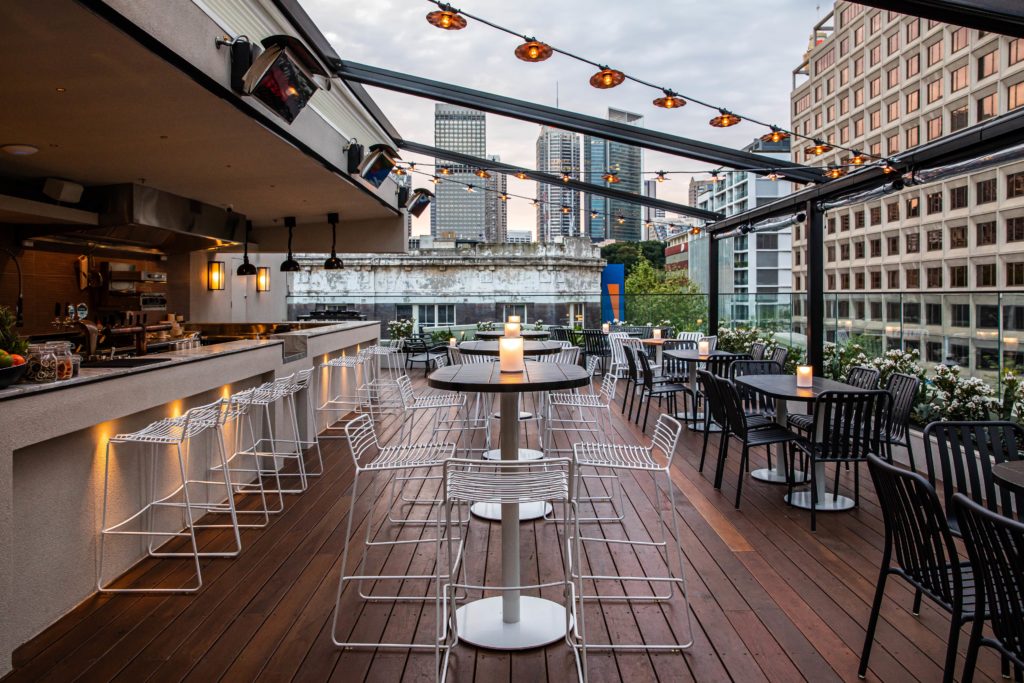 outdoor seating and bar at the strand rooftop