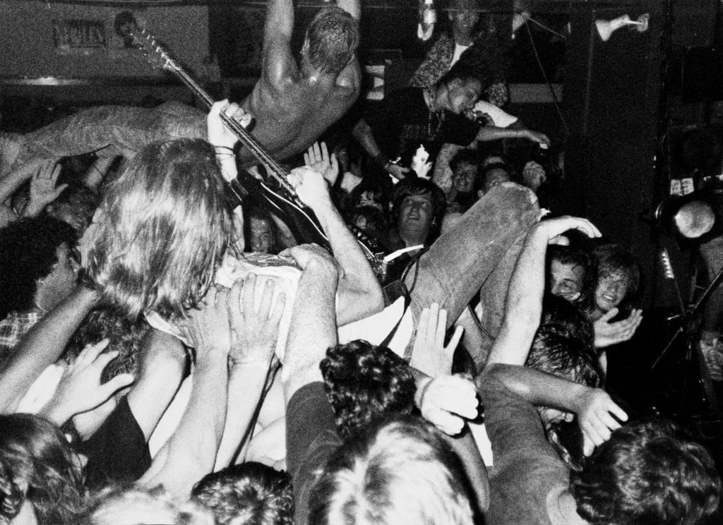 a black and white photo of people at a live music gig