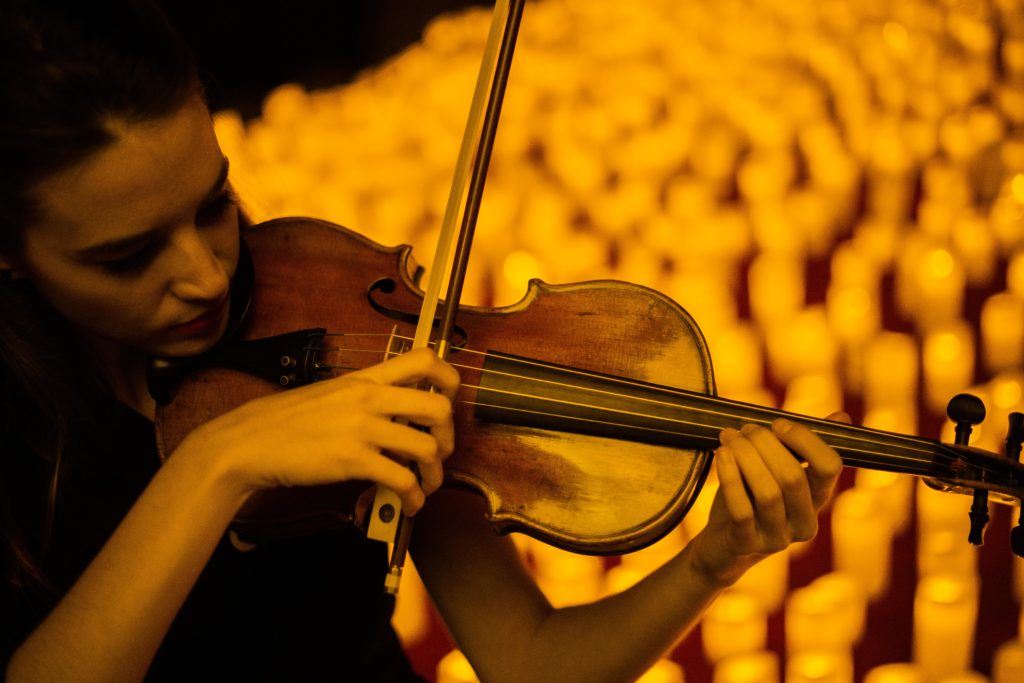 close up of violinst performing a candlelight concert