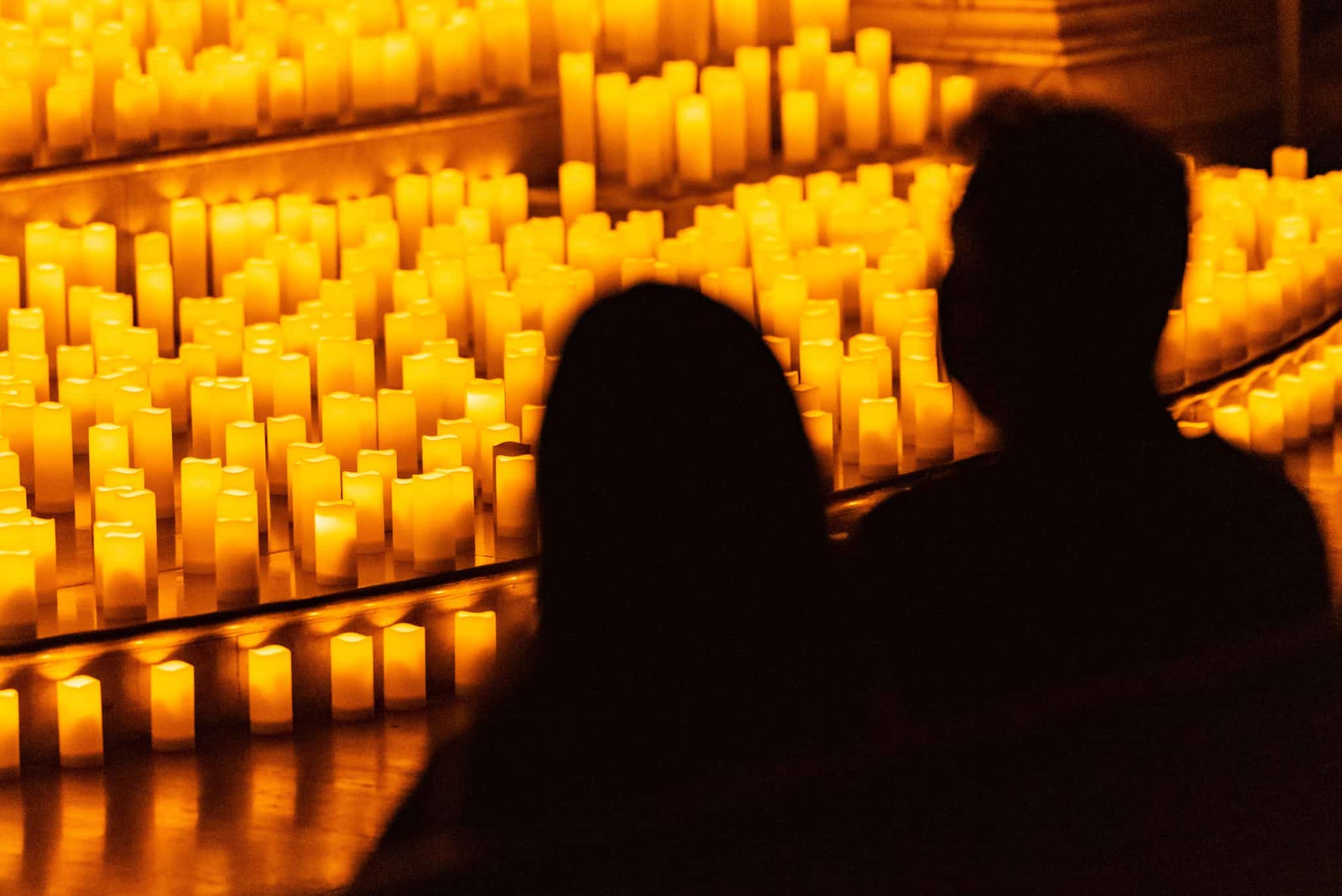 silhouette of couple enjoying a candlelight concert