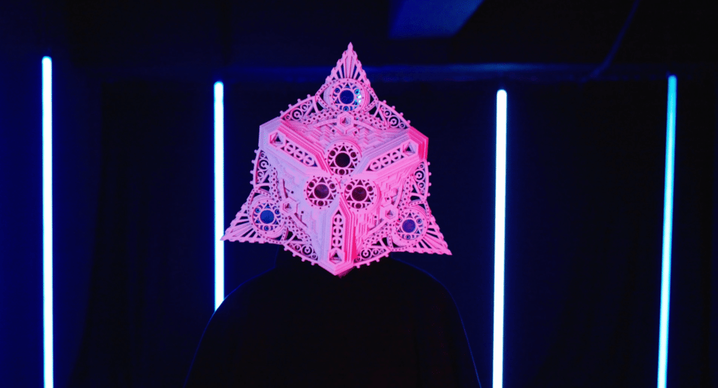 someone in a mask standing inside presence installatoion at enlightenment