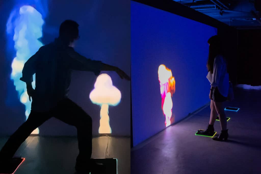 two images of the stomp light installation in action at enlightenment where plumes of coloured virtual smoke are relased on srceen 