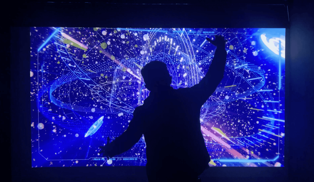 silhouette of man playing with hologram installation at Teleport Enlightenment