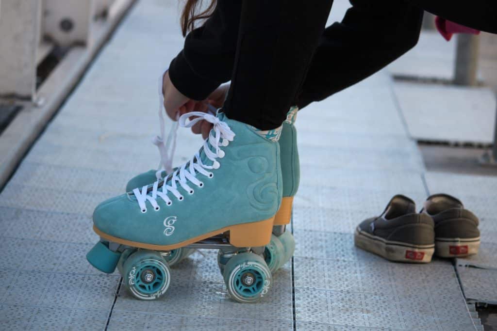 a person lacing roller skater