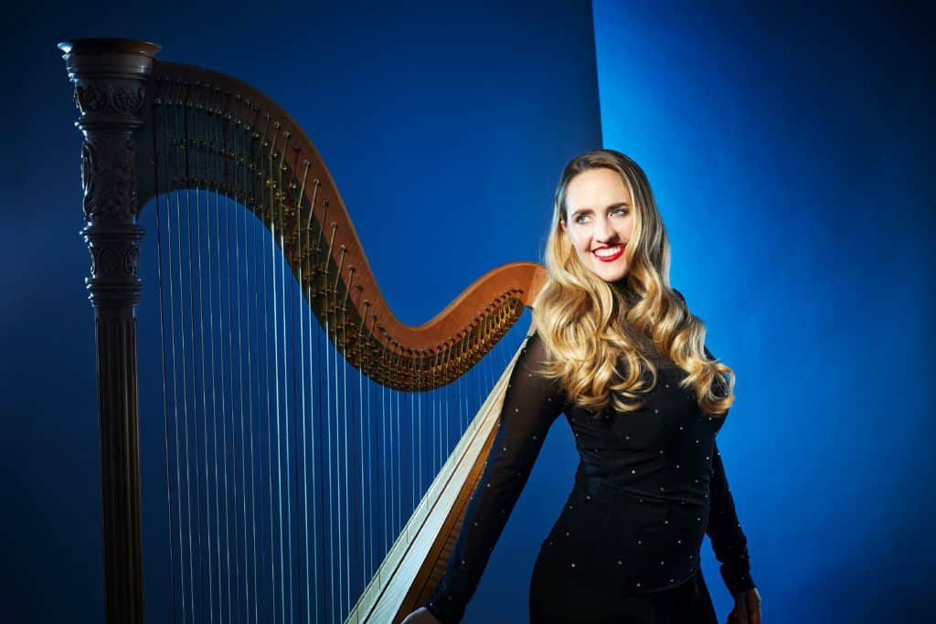 Emily Granger in front of her harp 