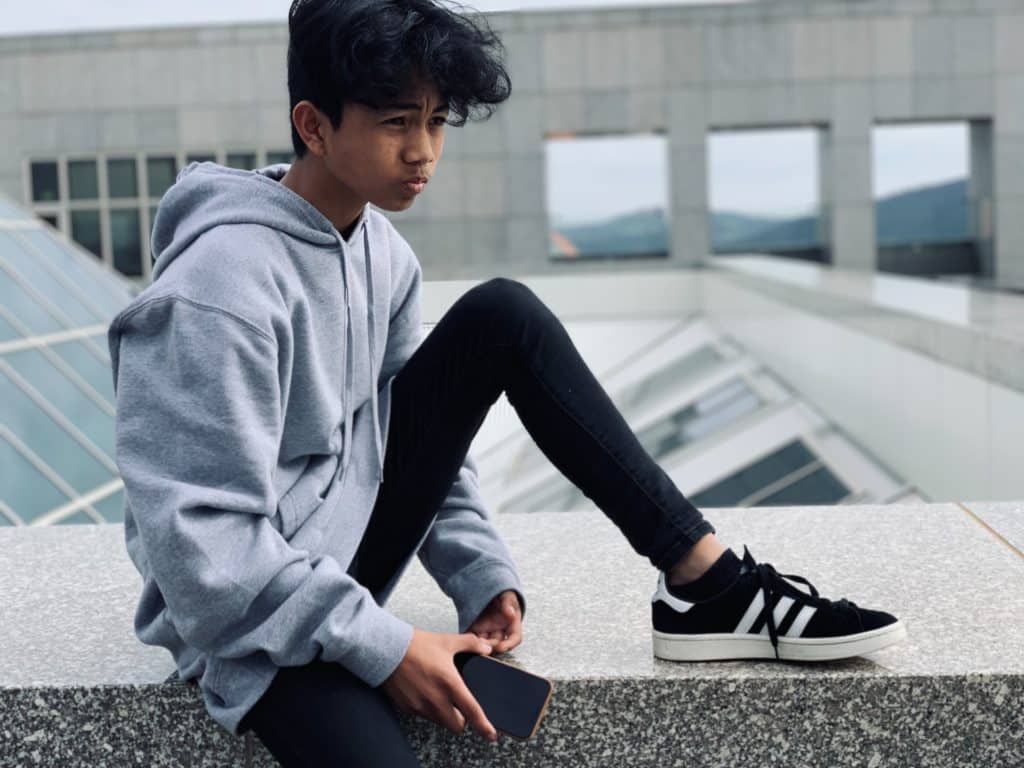 young australian sitting on outside of parliament house in canberra
