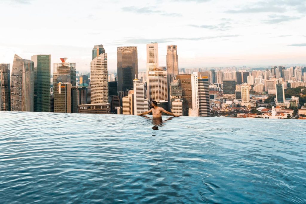 topless man in a rooftop infinity pool in Singapore