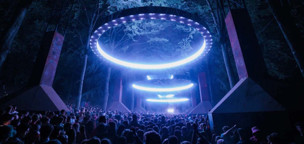 floating light rings above a crowd of people