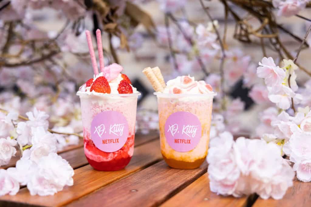 strawberry and peach bingsu (shaved ice cream) against a backdrop of cherry blossoms at the xo kitty pop-up cafe