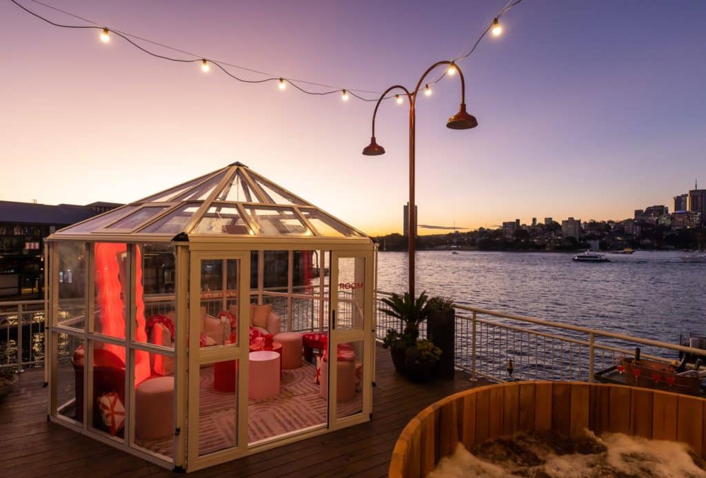 a glasshouse by the harbour with fairy lights