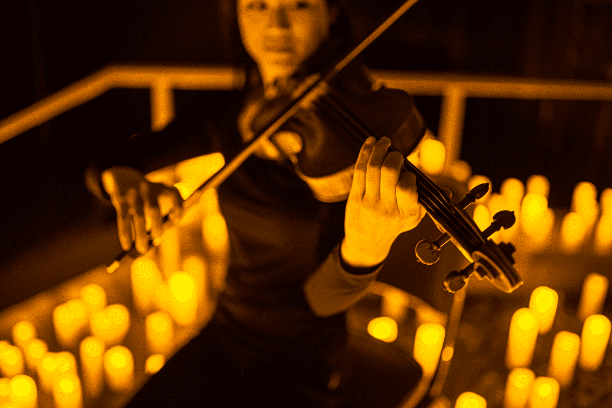 A musician performing by candlelight