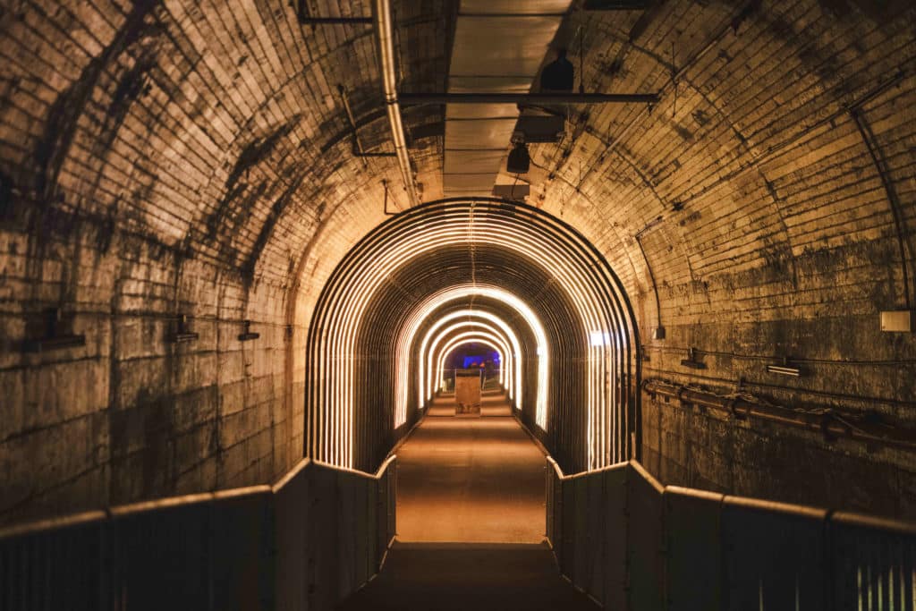 a lit up tunnel under wynyard station