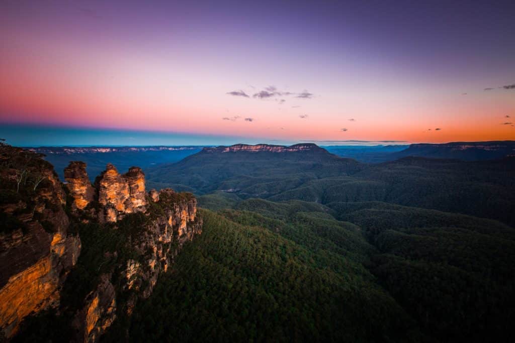 a view of the three sisters lookout point in the blue mountains